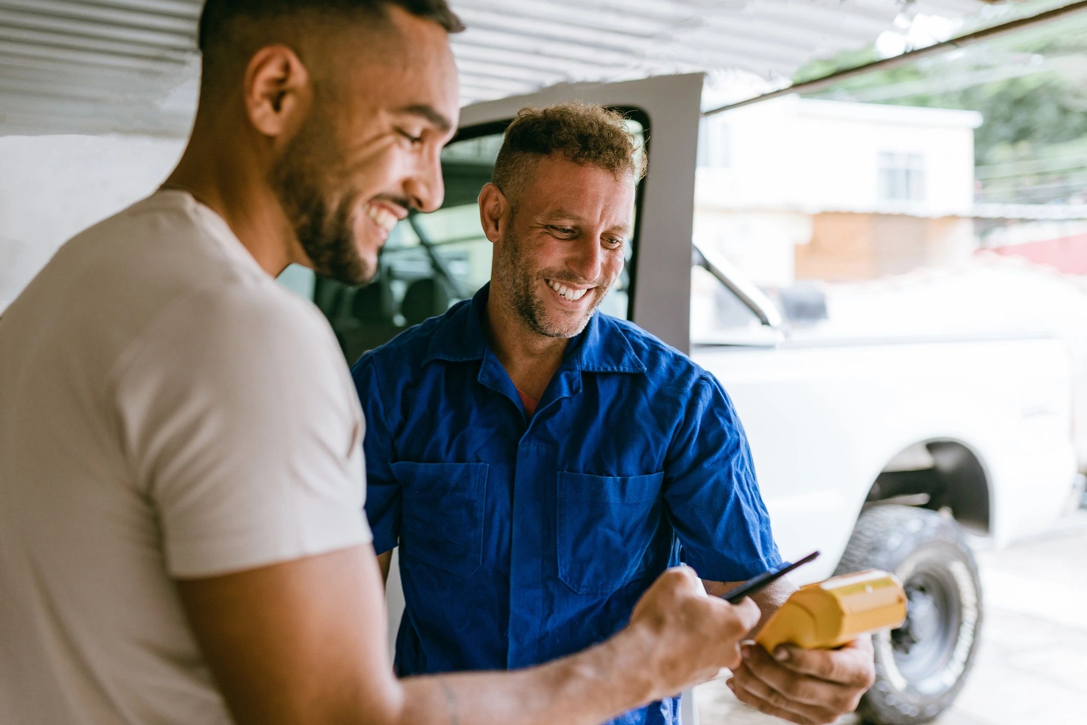 Customer making a contactless payment at an auto repair shop