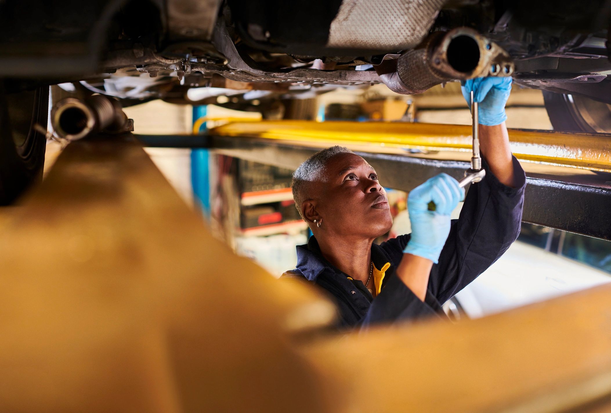 Mechanic performing vehicle service during parts replacement
