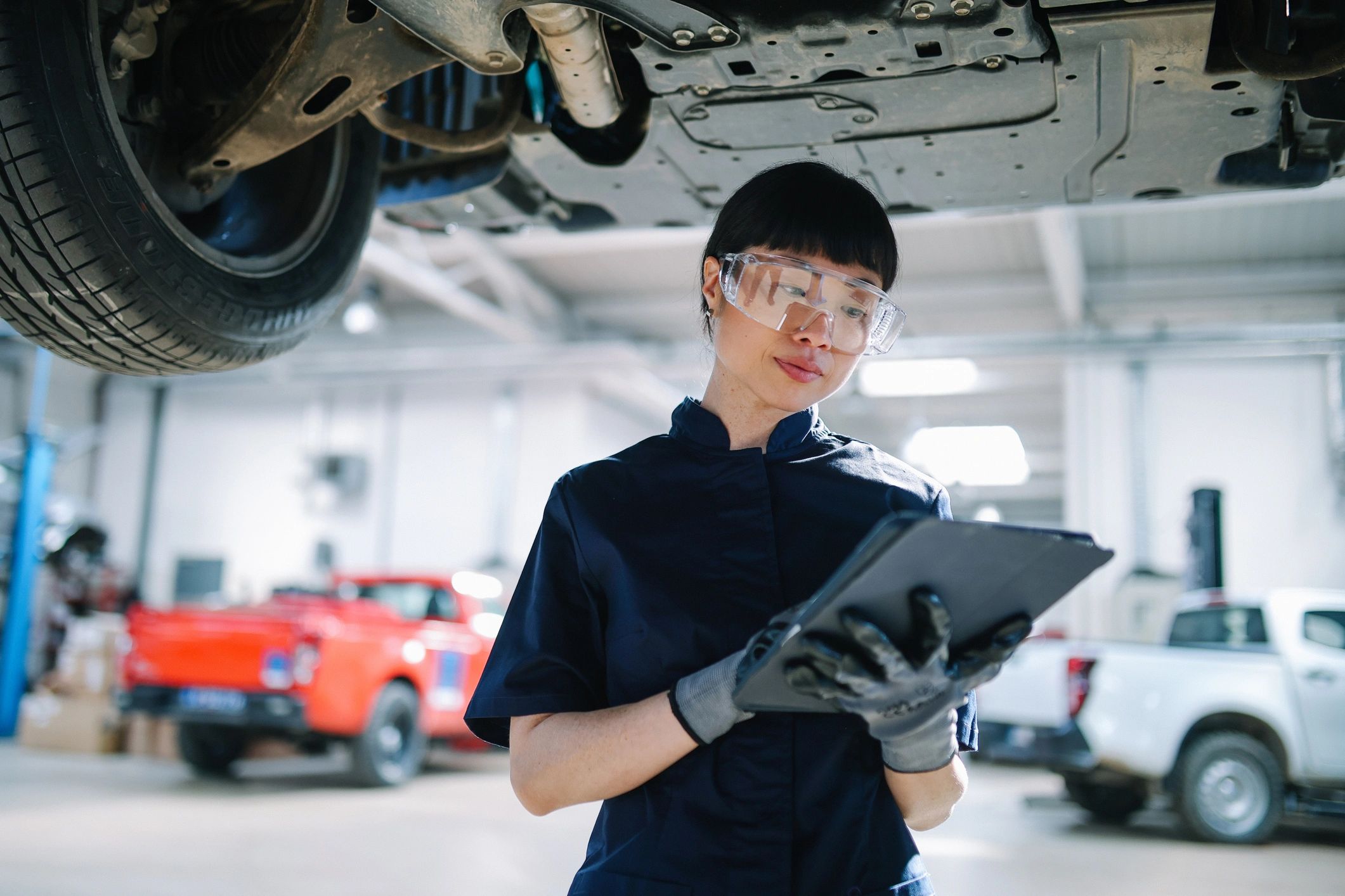 Technician using a tablet to document vehicle inspection