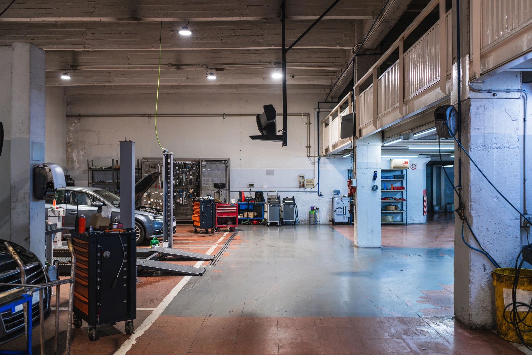 Car repair shop with lifts and toolboxes ready for mechanics