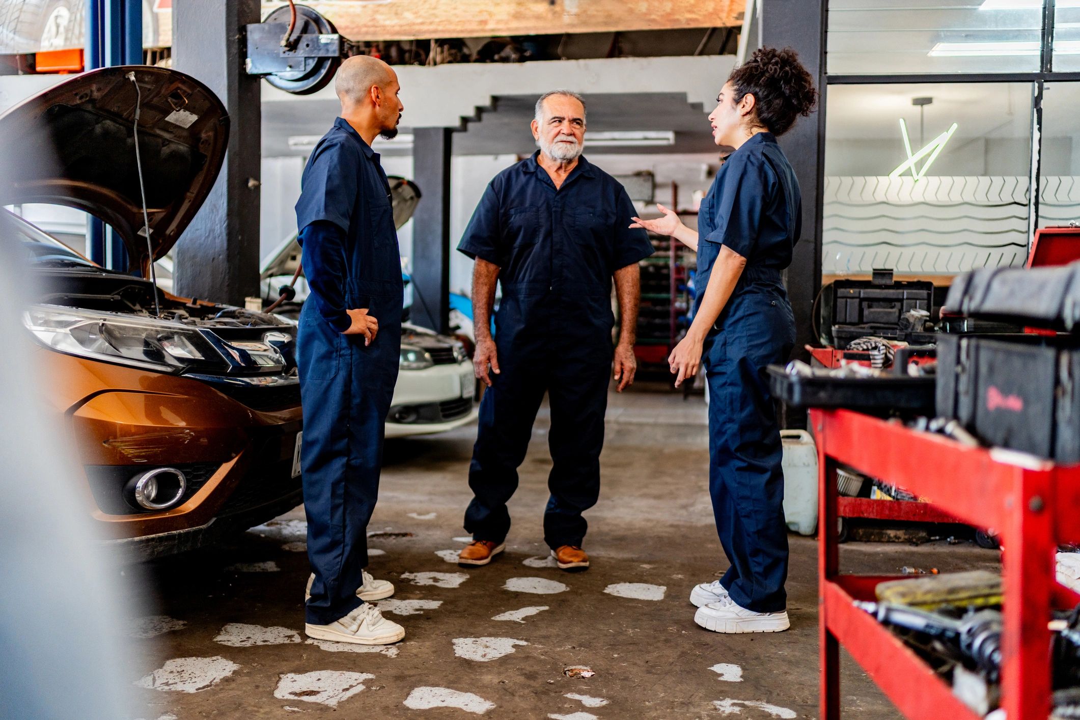 Mechanics talking at auto repair shop