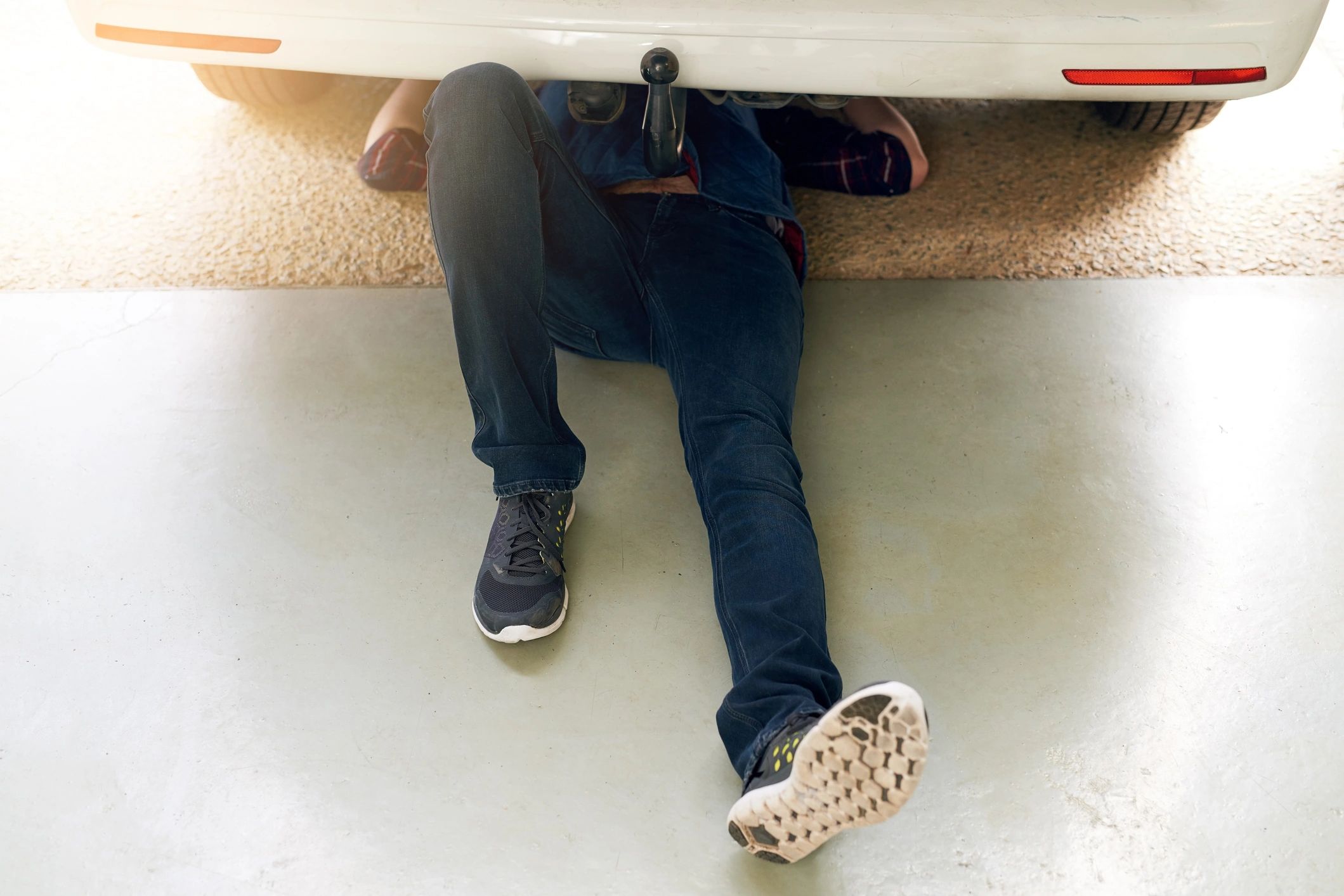 Mechanic working under a car on a lift